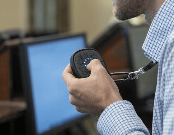 Dietitian holding electronic meal tracking device, monitoring nutrition in healthcare setting